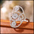 Diamond ring with three main diamonds on a wooden surface