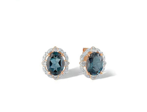A pair of oval stud earrings featuring dark blue topaz gemstones surrounded by small clear natural diamond stones and rose gold settings, shown on a clean white background.