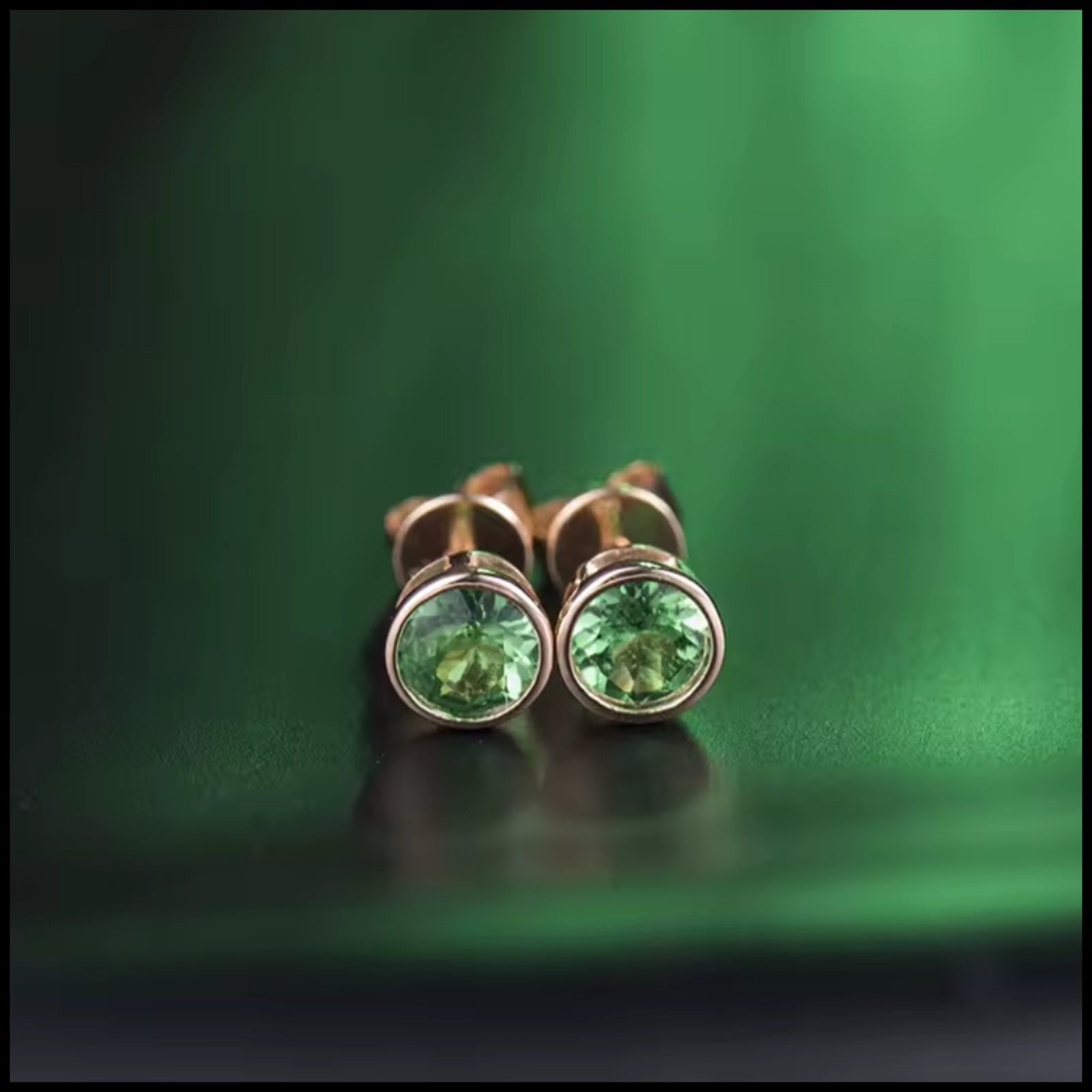 Tsavorite green stud earrings with round-cut gemstones set in 14k rose gold
