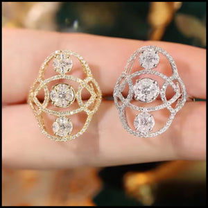 Gold diamond with gemstones held on a hand against a blurred background