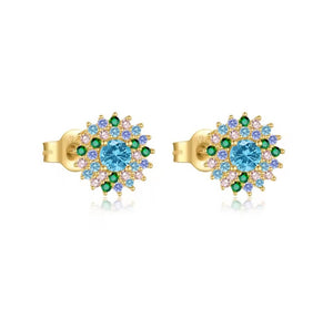 A pair of gold stud earrings featuring a central round light blue gemstone surrounded by smaller green, light blue, and clear accent stones, shown on a white background.