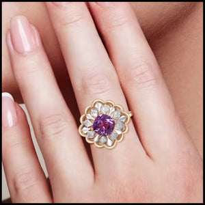 Purple amethyst and diamond flower ring in 14k yellow gold on finger