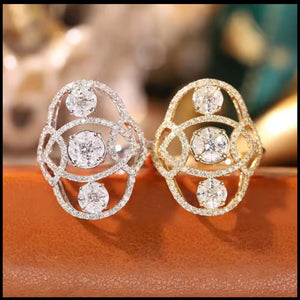 Pair of diamond rings on a reflective surface with a blurred background