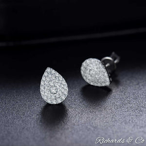 Diamond pear stud earrings in 14k white gold with natural round-cut diamonds and pink sapphire accents
