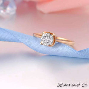 Diamond engagement rose gold ring with round cut natural diamonds in four prong setting on a delicate 14K rose gold band