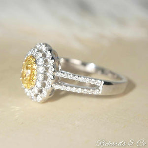 Yellow & White Halo Engagement Diamond Ring with oval yellow diamond center and white diamond halo set in 18K white gold