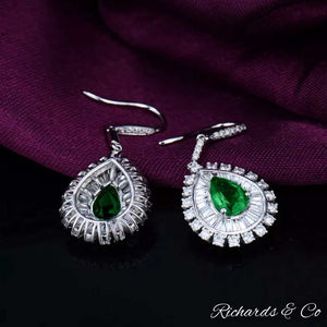 Clarity Drop Emerald & Diamond Earrings in 18k white gold with pear-shaped emeralds and round baguette diamonds