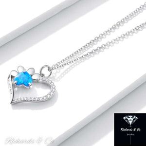 Heart-shaped silver necklace with blue zirconia paw design pendant on link chain