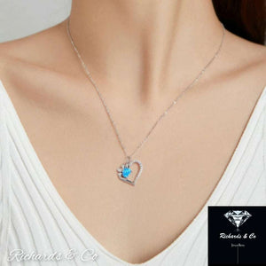 Heart Blue Zirconia silver necklace with paw print heart pendant on model neckline