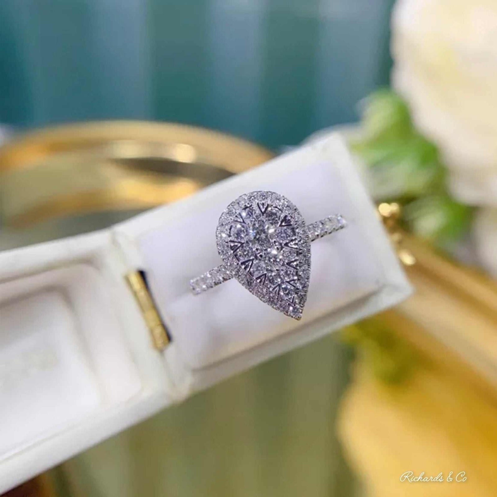 Diamond Pear Engagement Ring in 18K white gold with flawless round and pear cut diamonds, prong setting.