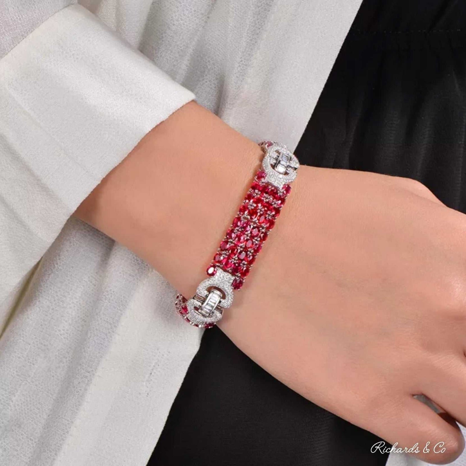 LANCY Ruby & Diamond Bracelet in 18K white gold with 24.7ct oval rubies and 2.55ct round cut diamonds on wrist