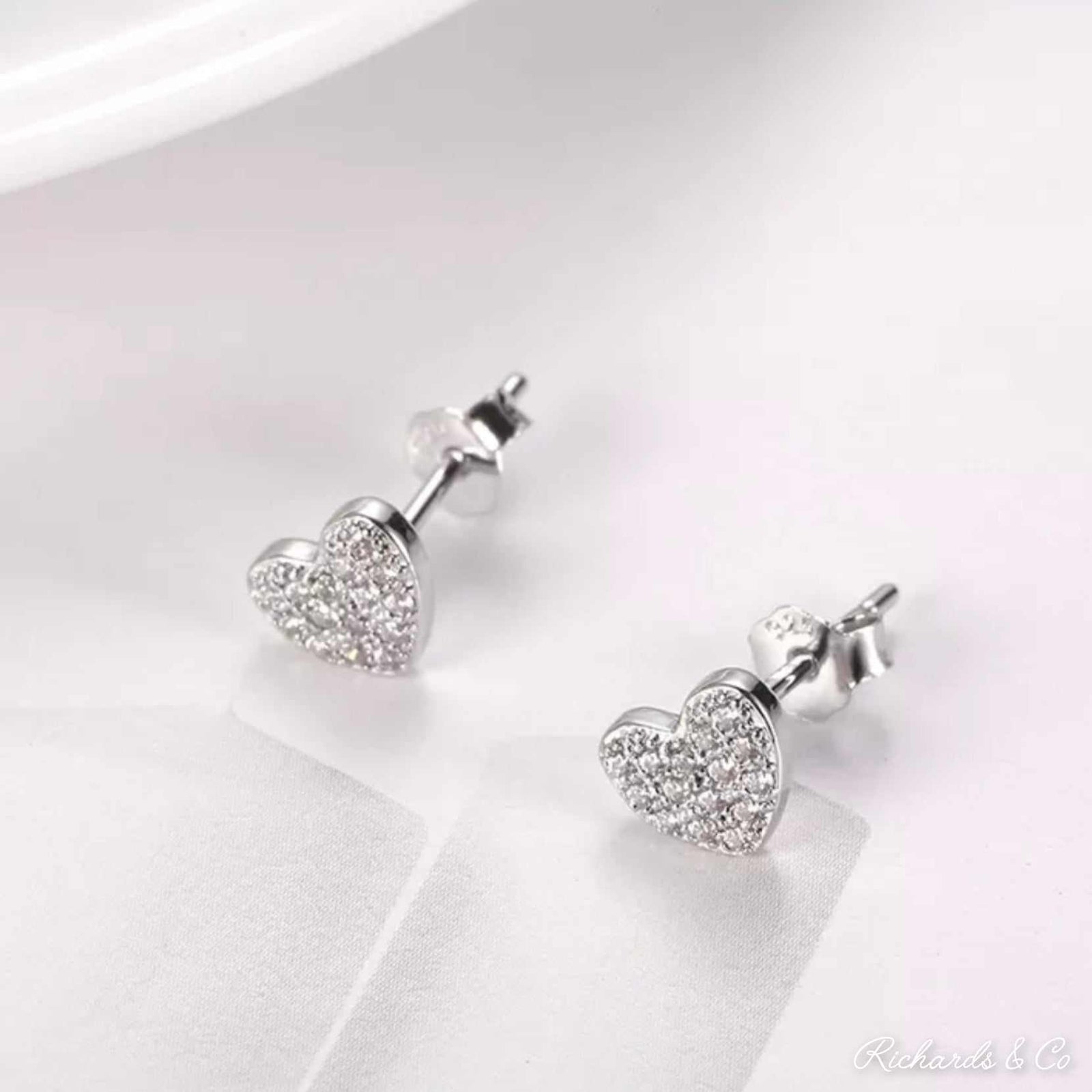 Heart silver earrings with zirconia-studded delicate heart design studs in solid silver, 6.5mm x 5.7mm size, handcrafted jewelry pair
