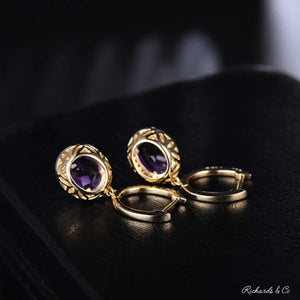 Purple amethyst and diamond drop earrings set in 14k yellow gold with oval purple amethyst stones and round natural diamonds
