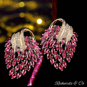Elegant pink ruby and diamond earrings in 14K yellow gold with marquise-shaped pink rubies and round-cut diamonds