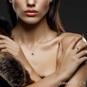 Collection - DEVOTION heart necklace pendant with sapphire and diamonds in 14K yellow gold worn by woman