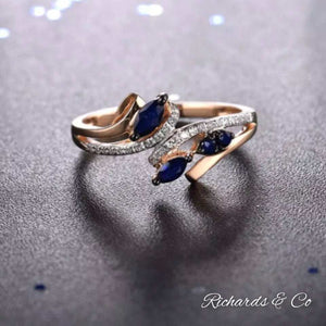 14K rose gold ring with sapphire and diamond stones in a trendy prong setting