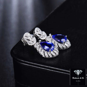 14K white gold Tanzanite and diamond drop earrings with pear-cut blue tanzanite and round brilliant diamonds