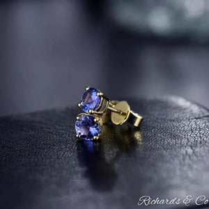 Natural Tanzanite stud earrings in 14K yellow gold with round 5mm VS clarity gemstones showcasing violet blue hues