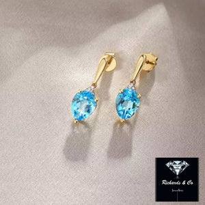 14K yellow gold earrings with pear-shaped Swiss Blue Topaz & Diamond studs