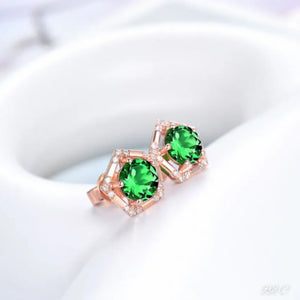 A pair of rose gold stud earrings, featuring a round-cut green tsavorite and a round-cut natural diamond.