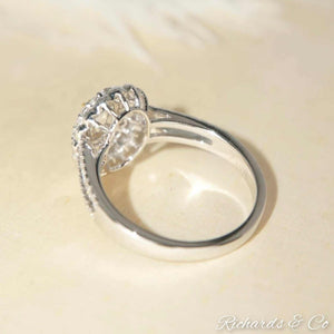 Yellow and white halo engagement diamond ring in 18K white gold with oval center stone and prong setting