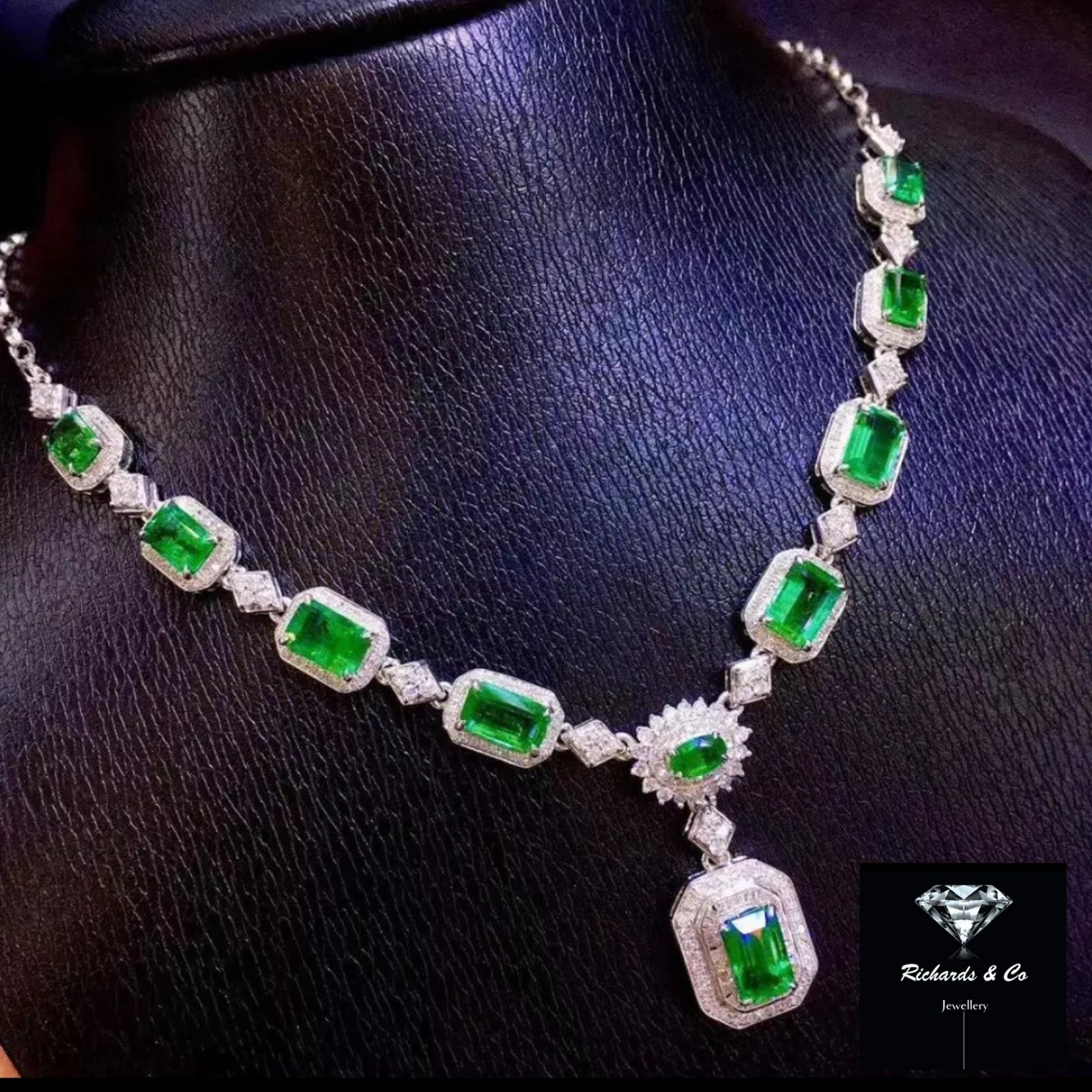 Elegant emerald and diamond necklace in 18K white gold, featuring 8.2ct emeralds and 2.02ct diamonds totaling 475 stones.