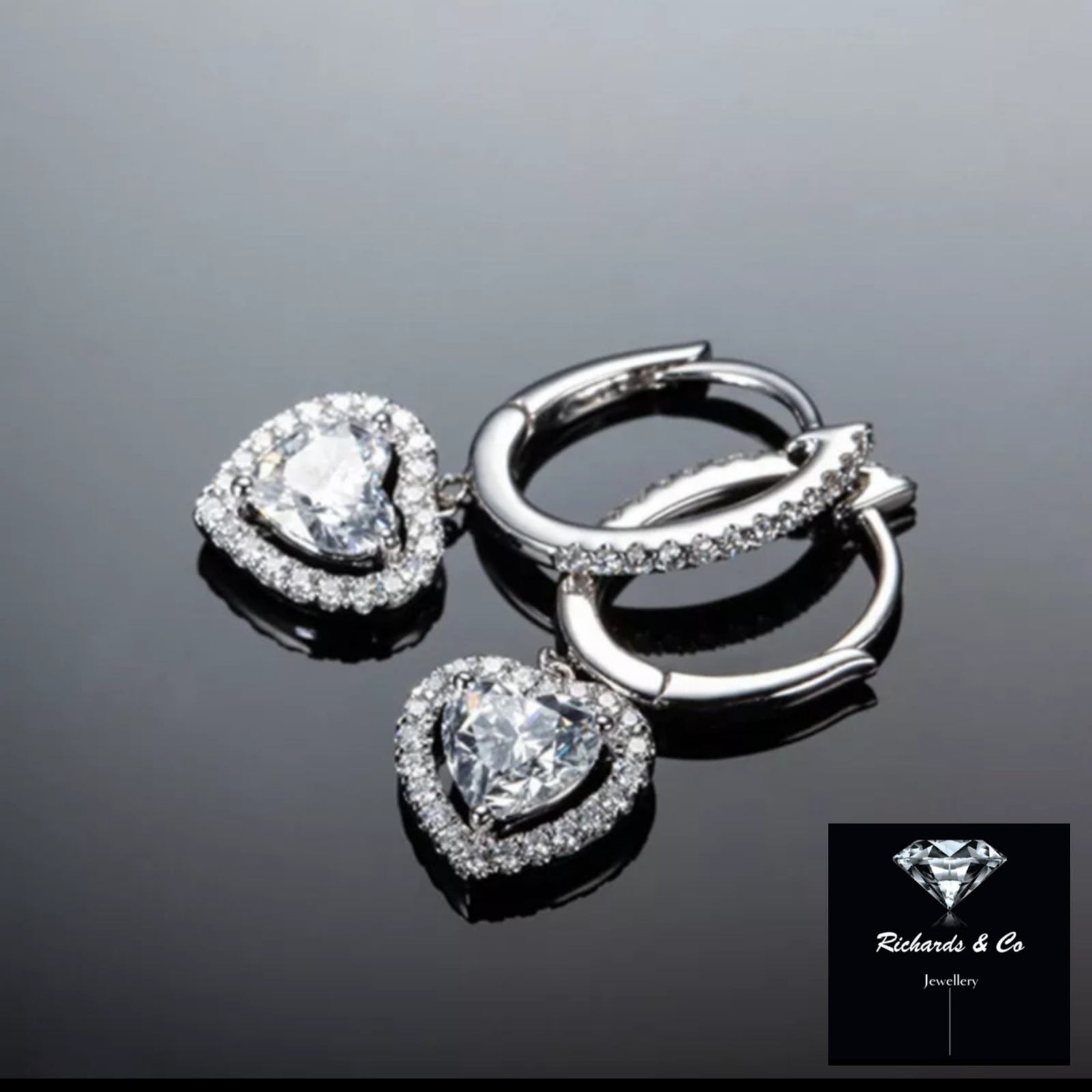 18k white gold heart diamond earrings with round cut side stones and heart-shaped main stones