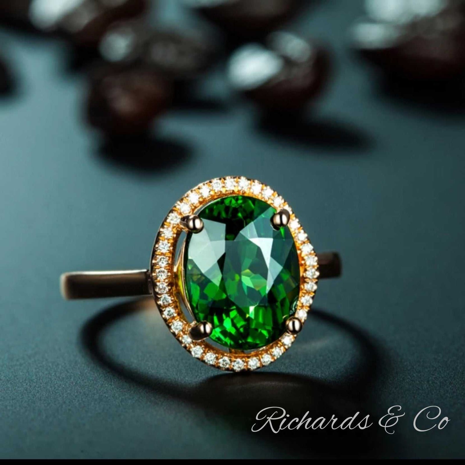18k rose gold ring with oval green tourmaline center stone and diamond cluster setting