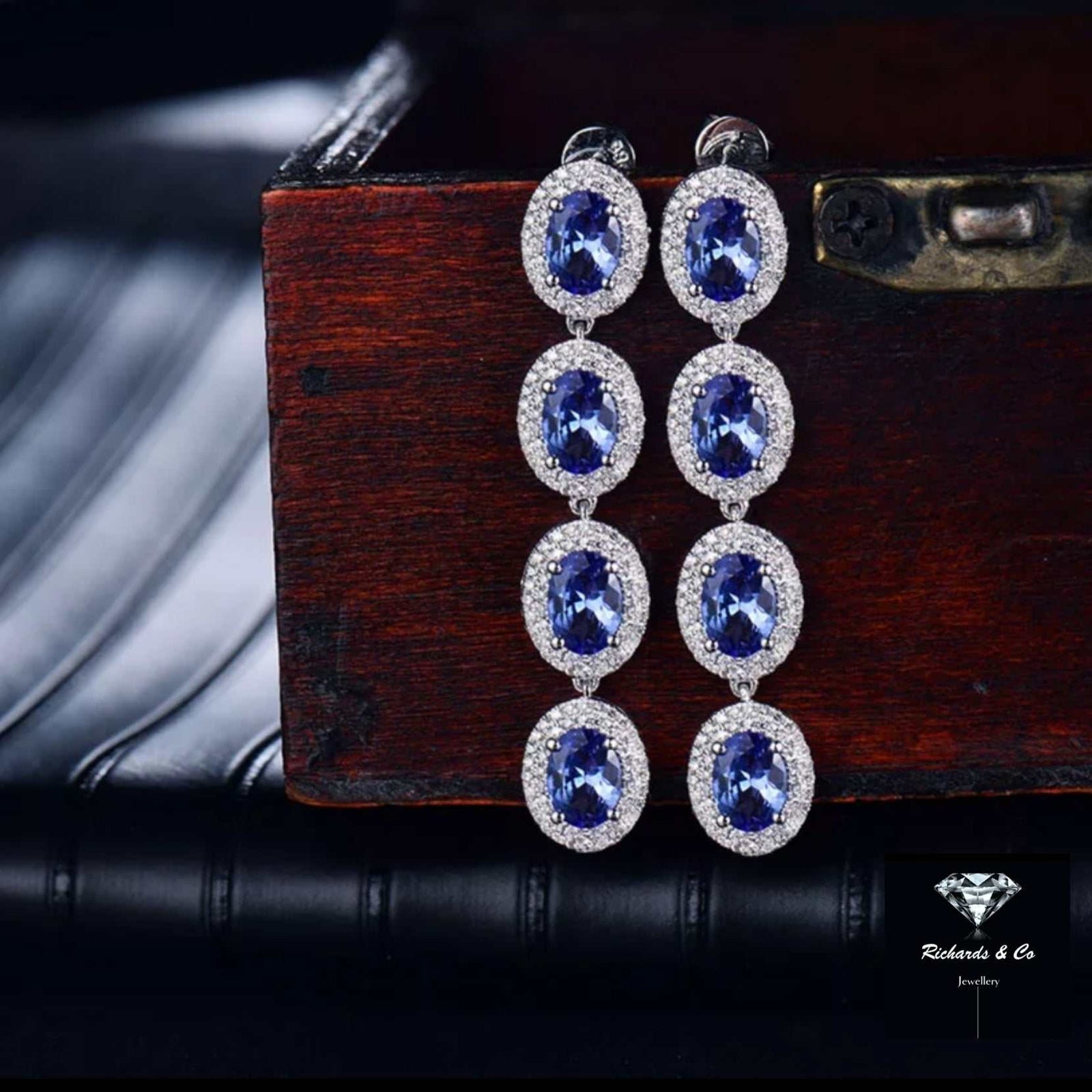 Elegant Tanzanite and Diamond Drop Earrings set in 14k white gold with oval cut tanzanite and round natural diamonds