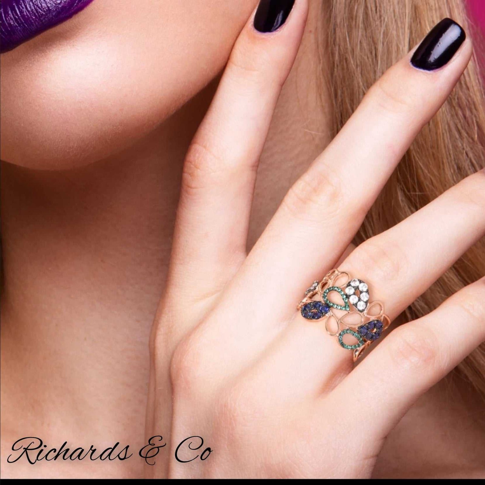 Rose gold multi crystal ring with hollow design and intricate water drop pattern on hand