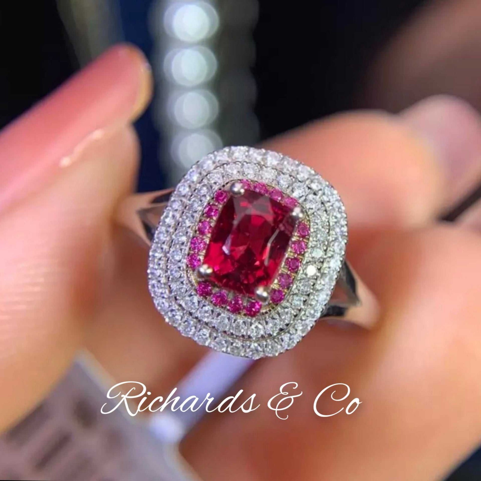White gold ring with central red spinel gemstone surrounded by two rows of sparkling diamonds diamonds & spinel jewelry