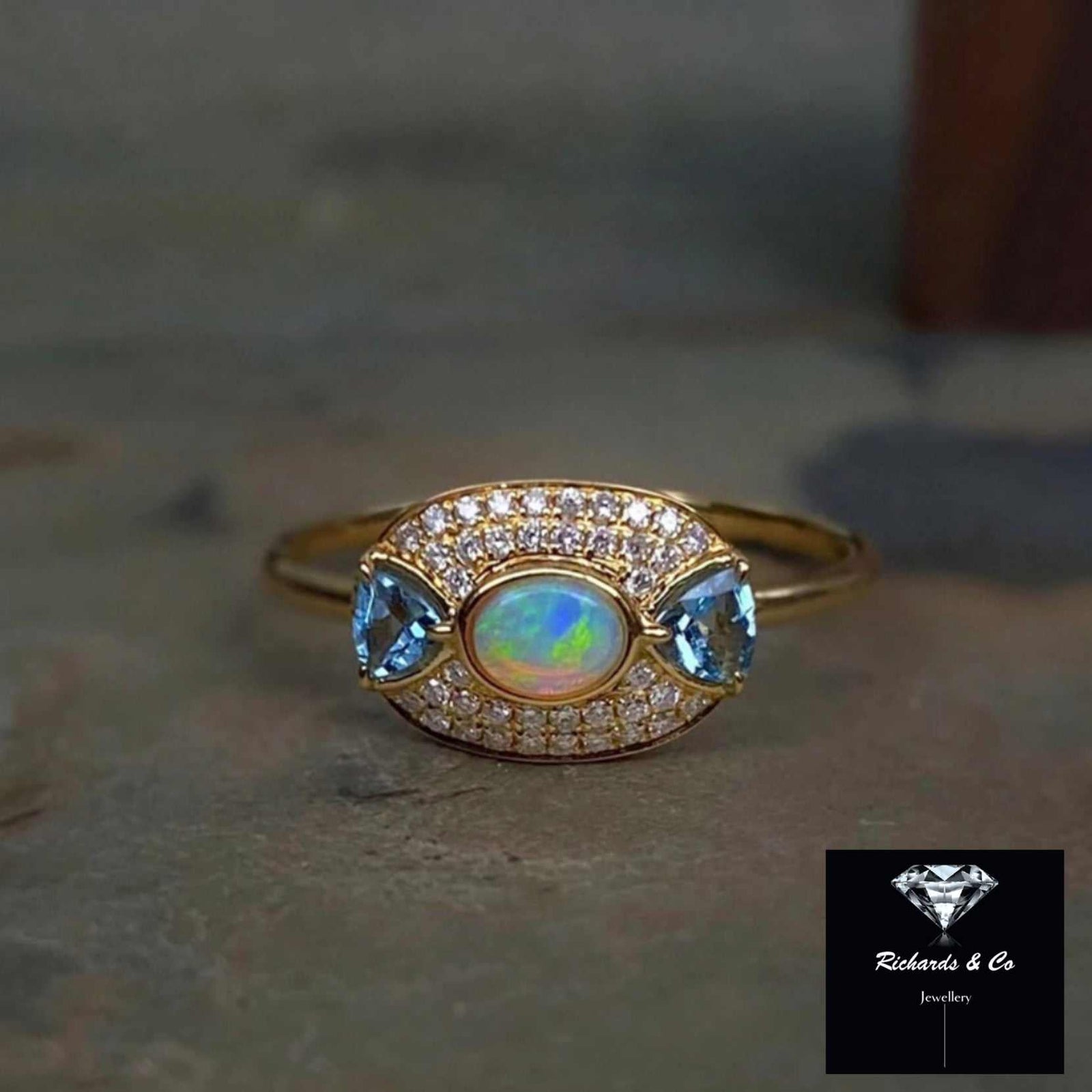 18k yellow gold ring with opal, blue sapphires, and diamonds
