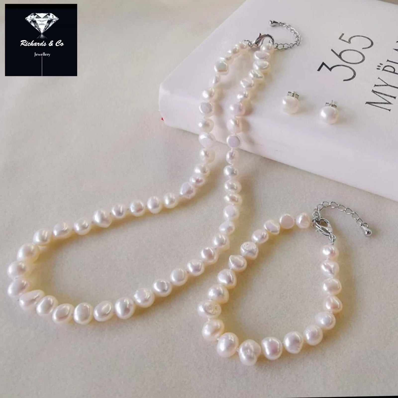 Matching pearl set with necklace, bracelet, and earrings featuring natural freshwater pearls and sterling silver accents