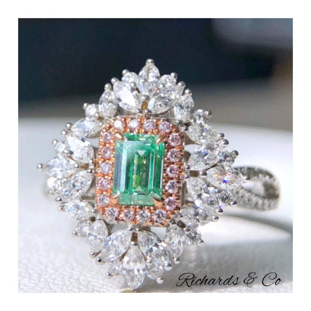 Fancy Light Green Diamond 0.51ct emerald cut ring in 18K white gold with prong setting and surrounding white diamonds