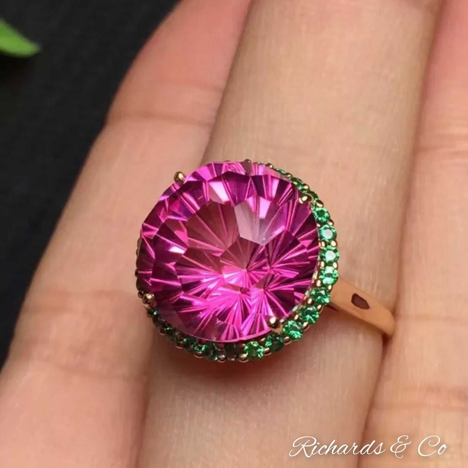 Pink Topaz and Green Tsavirites Ring set in solid 18k gold with vibrant pink topaz center stone and sparkling green tsavirites in prong setting