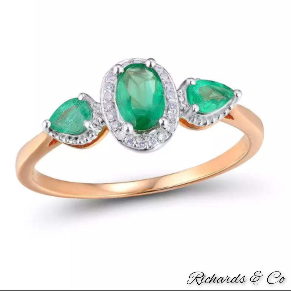 Emerald and diamond 14k rose gold ring with oval and pear cut emeralds and round diamonds in prong setting