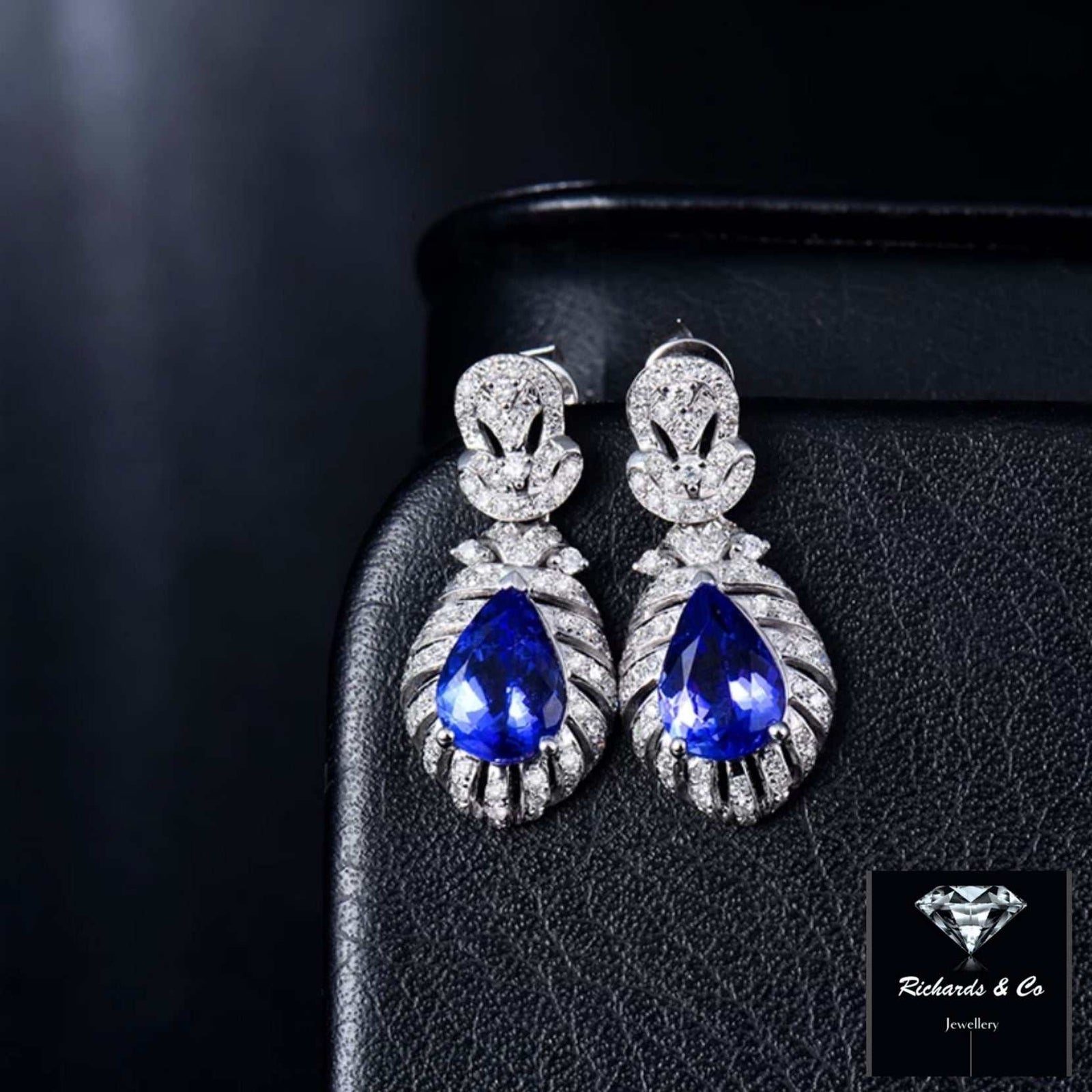 Elegant pear-cut blue tanzanite and round diamond drop earrings set in 14K white gold