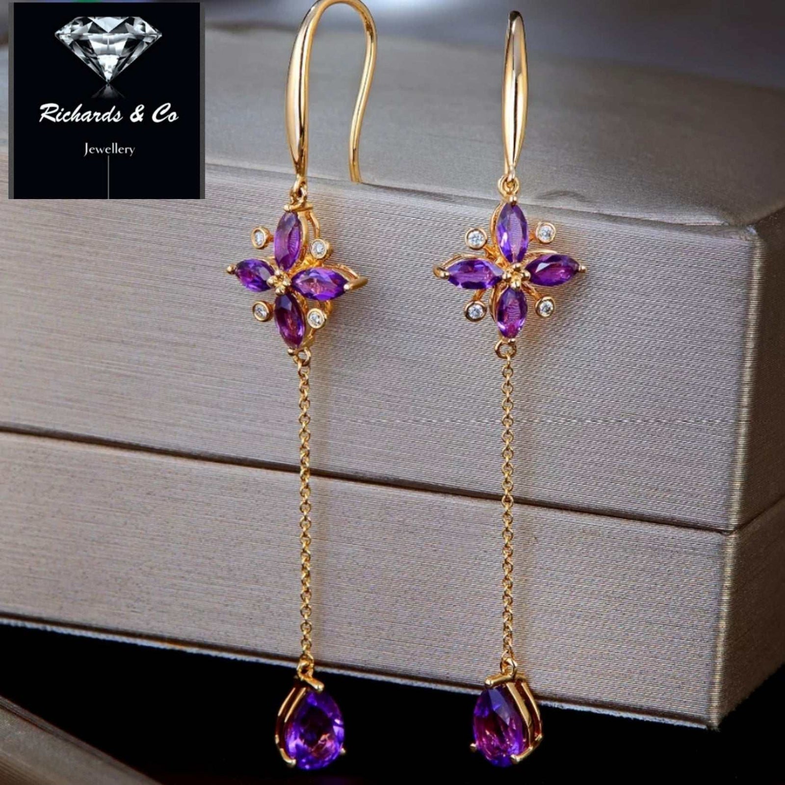 Elegant purple amethyst drop earrings with diamonds set in 14K yellow gold