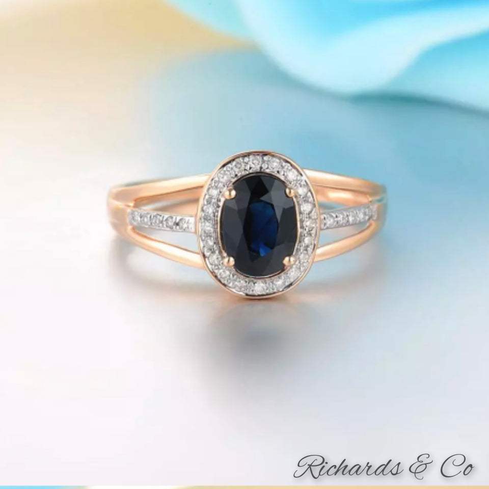 Sapphire and diamond 14K gold ring with oval blue sapphire center and round diamonds in rose gold setting