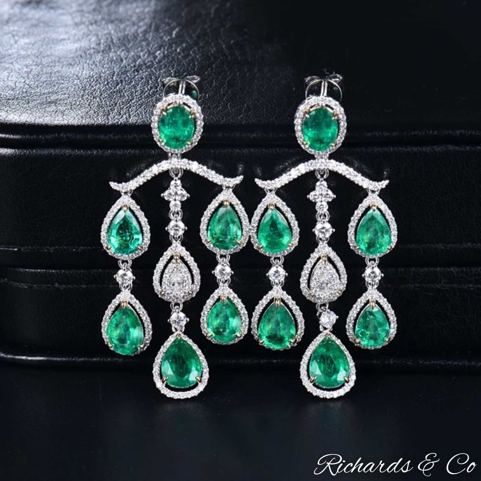 High end luxury handmade chandelier earrings with natural emeralds and diamonds in 18K white gold