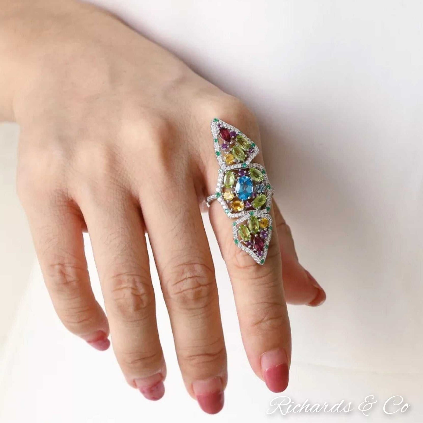 Bedlam Beauty Ring with multiple natural gemstones in silver, including topaz, garnet, peridot, citrine, and amethyst.