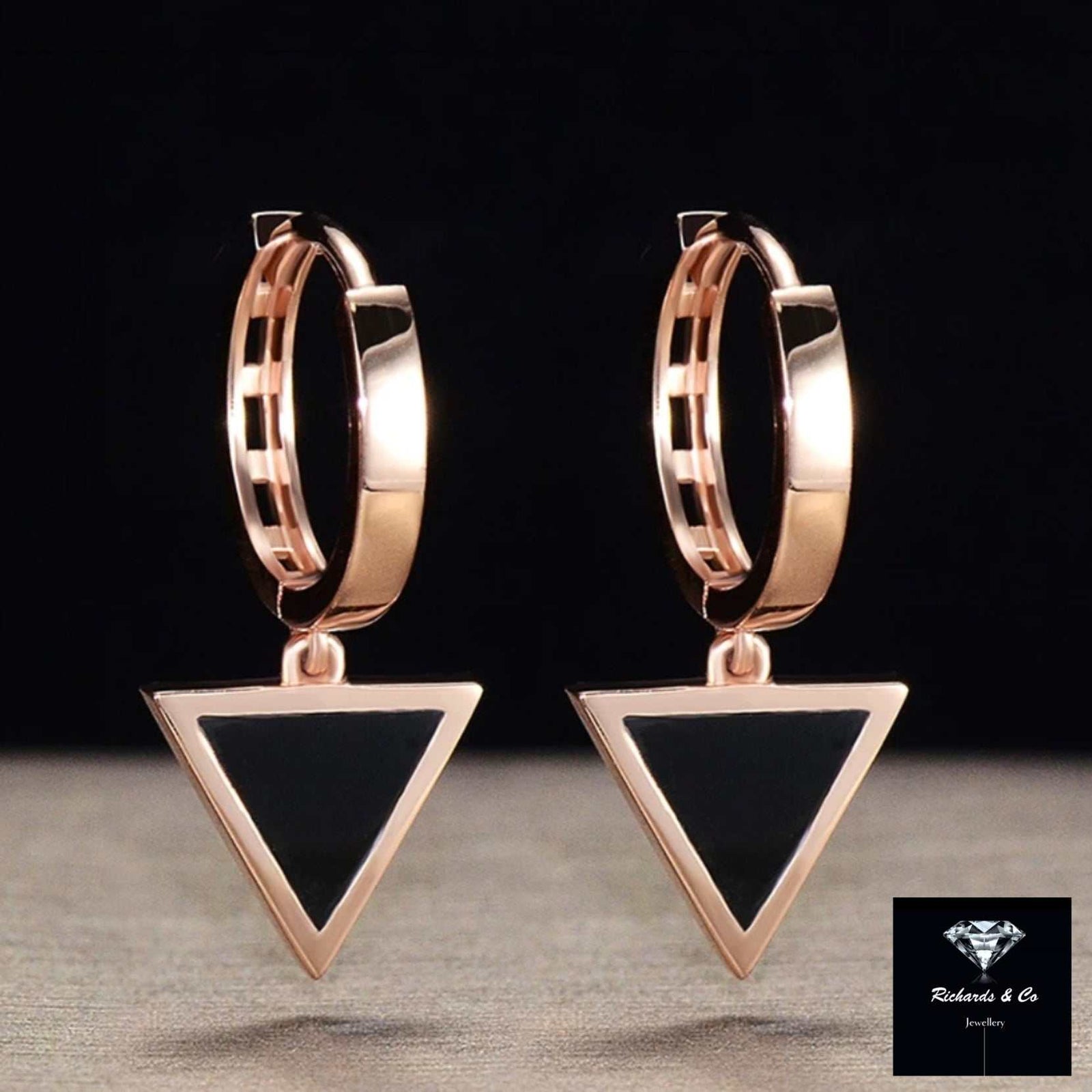 Pair of black agate triangle drop earrings set in 18K rose gold with geometric design