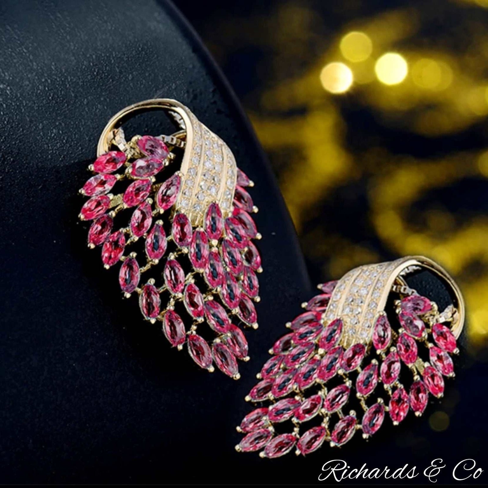 Elegant pink ruby and diamond earrings in 14K yellow gold with marquise-shaped rubies and round diamonds