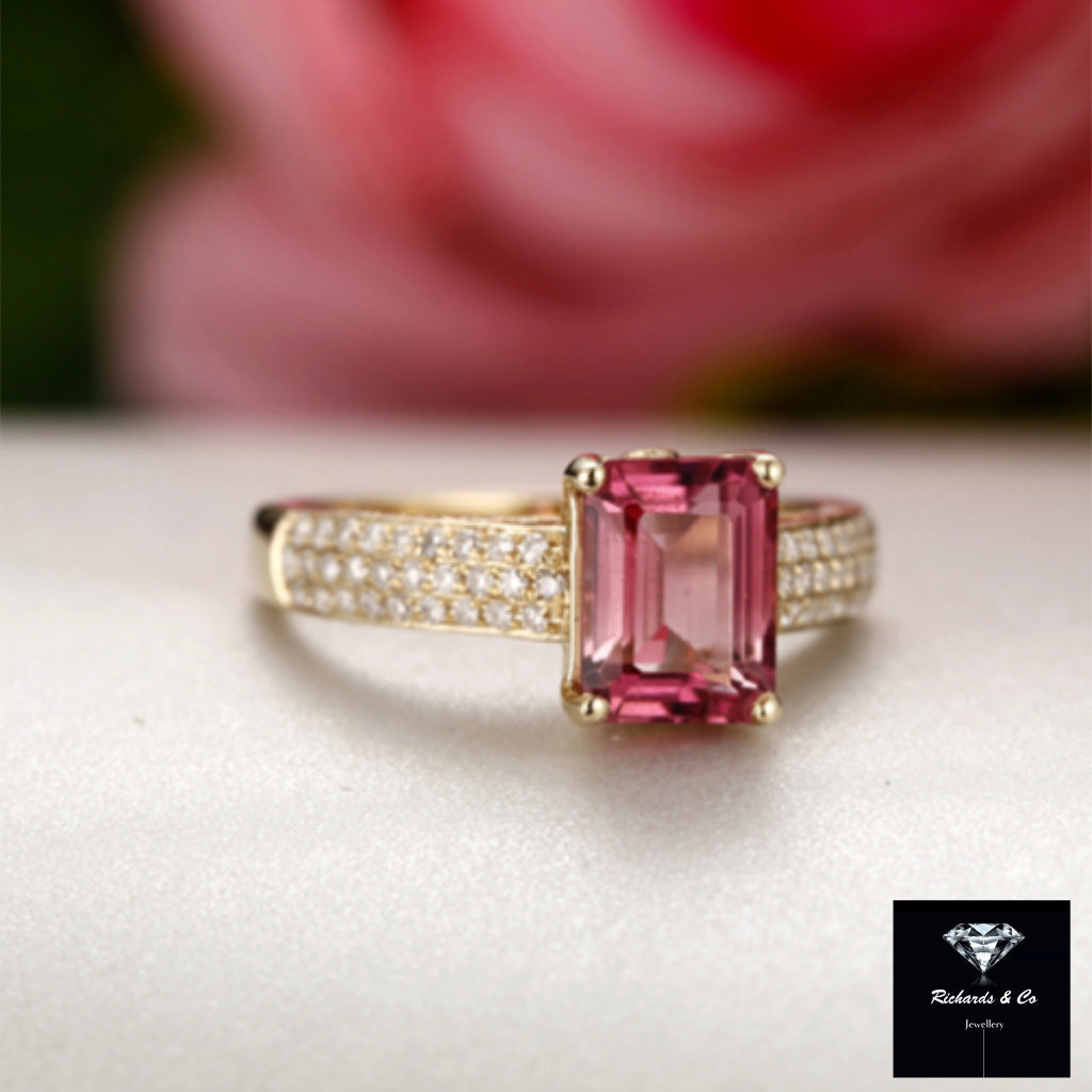 Pink tourmaline and diamond ring set in 18k yellow gold with prong setting and pavé diamonds on band