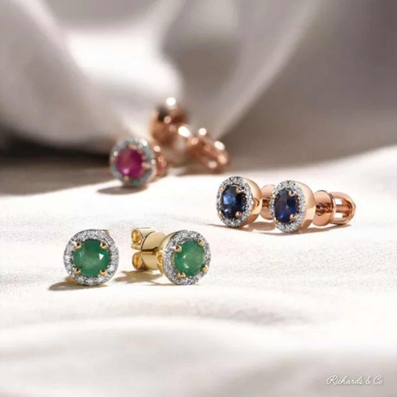 BIANCA Collection 14K gold stud earrings with round cut ruby, emerald, and blue sapphire surrounded by diamonds