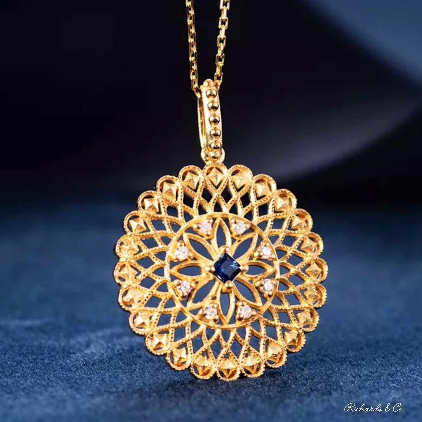 Elegant sapphire and diamond necklace pendant set in 18K yellow gold on a delicate gold chain