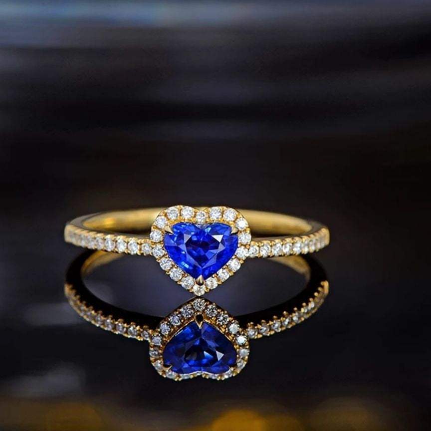 14k yellow gold Heart Sapphire ring with a 0.60ct blue heart-cut sapphire surrounded by 0.15ct round diamonds in bezel setting